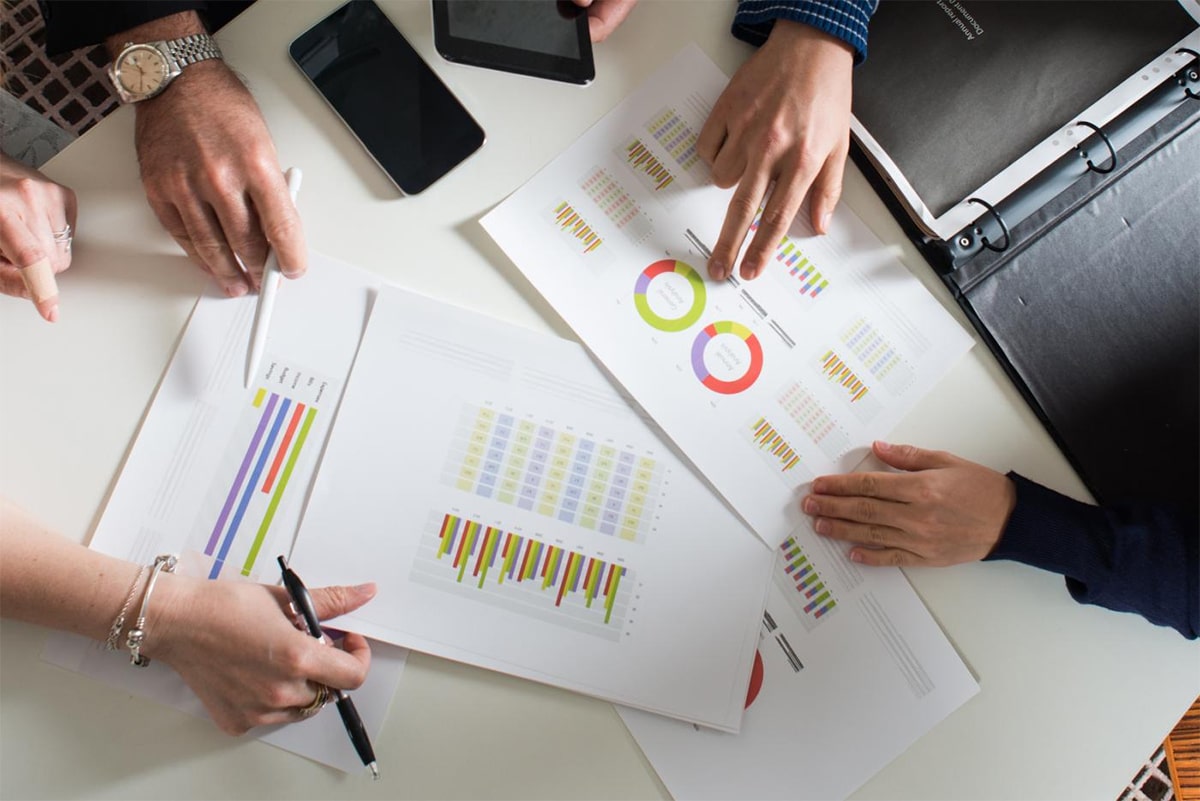 Traders and printed charts on the table